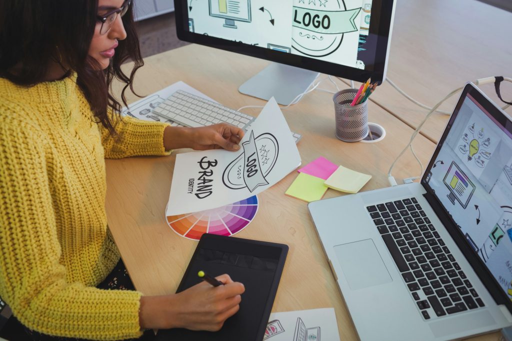 Young graphic designer working at office desk